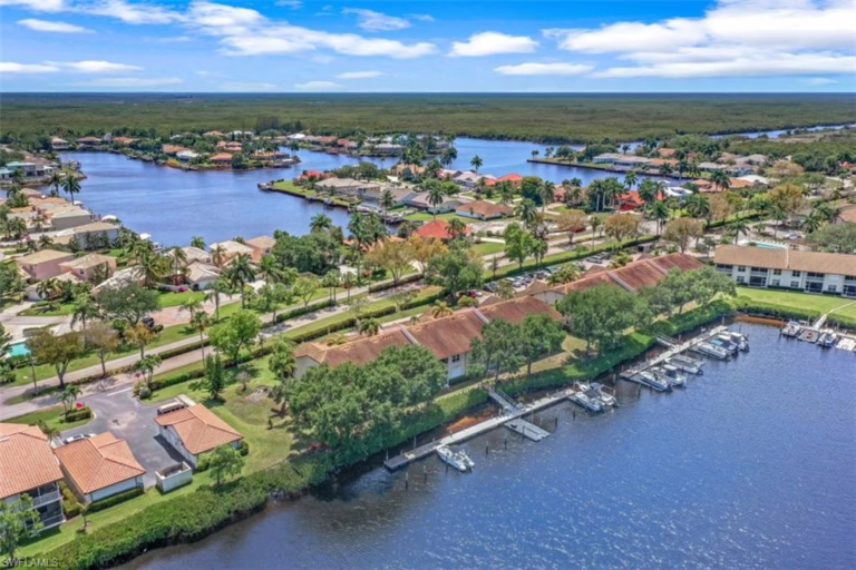 Drone photo of Sunset Cay Villas at Port of the Islands waterfront condos in Naples, FL